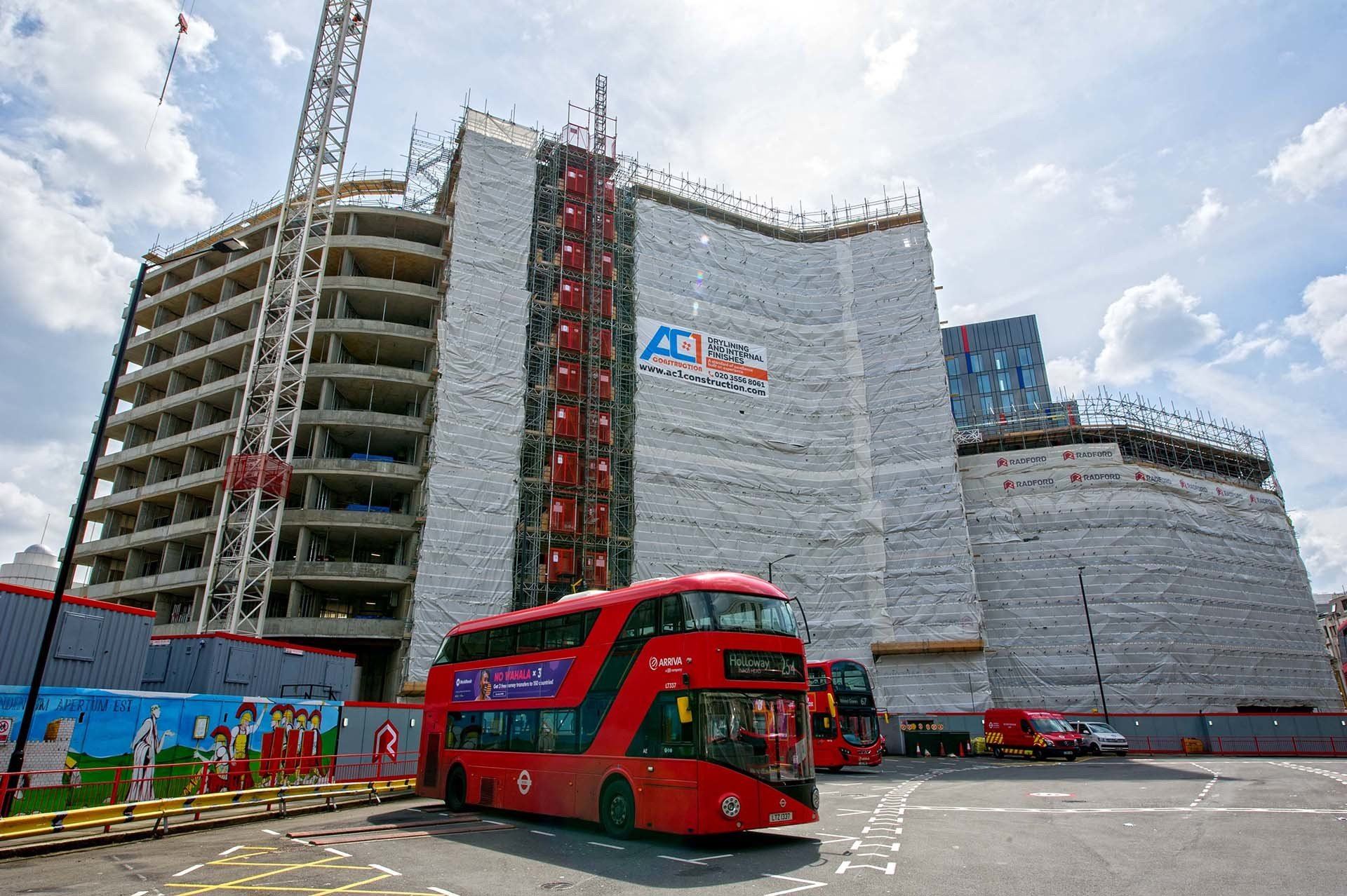 AC1 Construction branded scaffold banner on a multi-storey London build