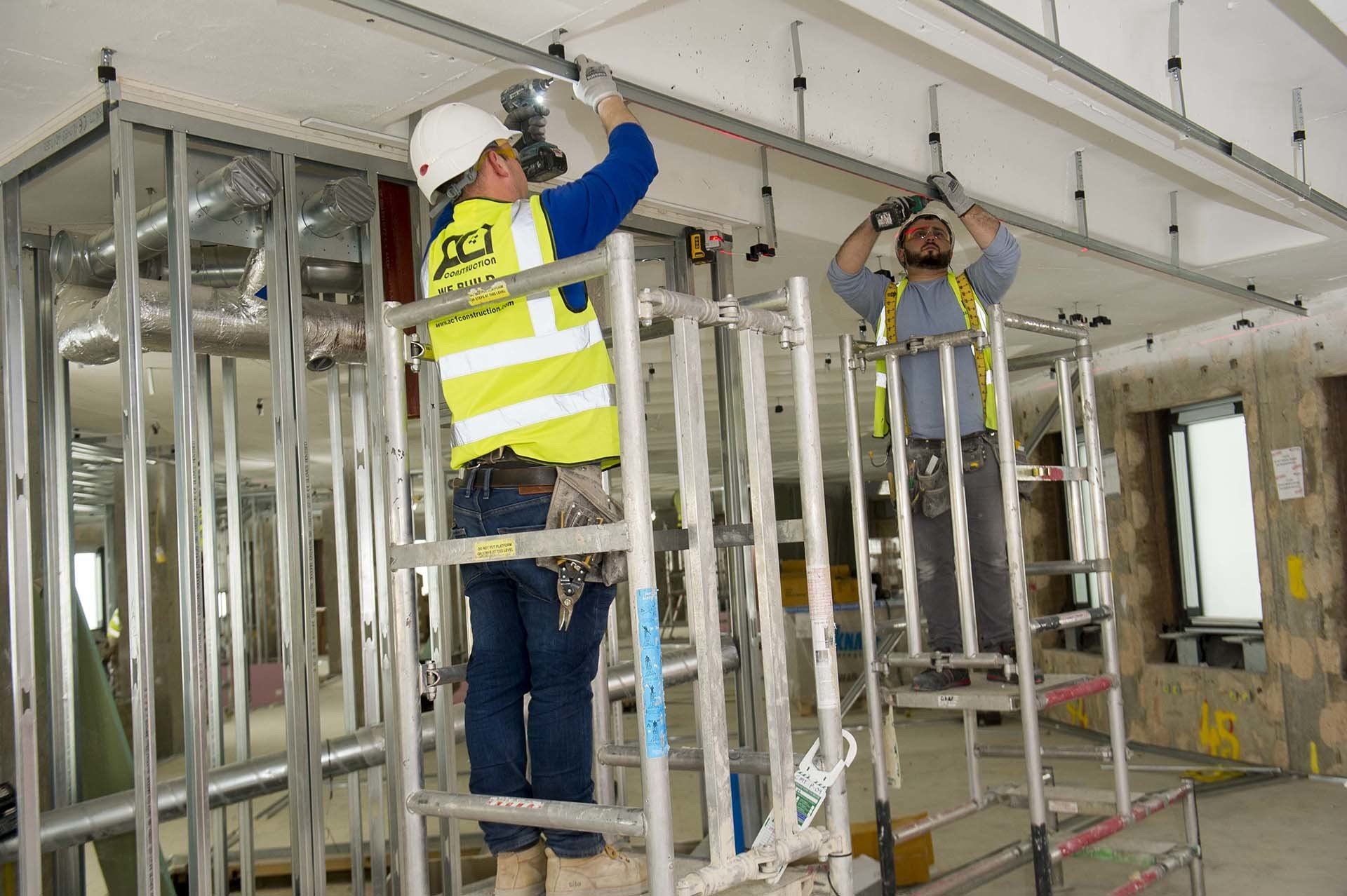 AC1 operatives installing metal stud framing from mobile towers