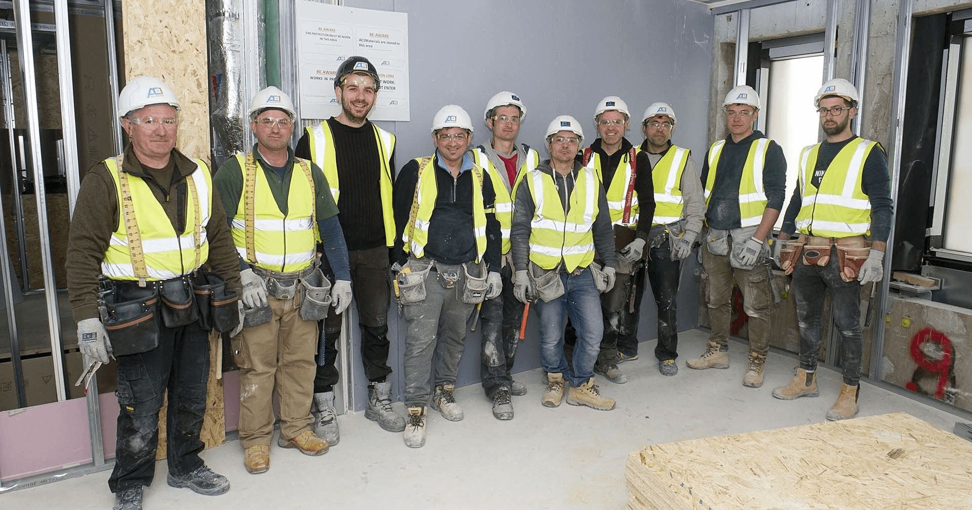 AC1 Construction operatives in branded hi-vis
